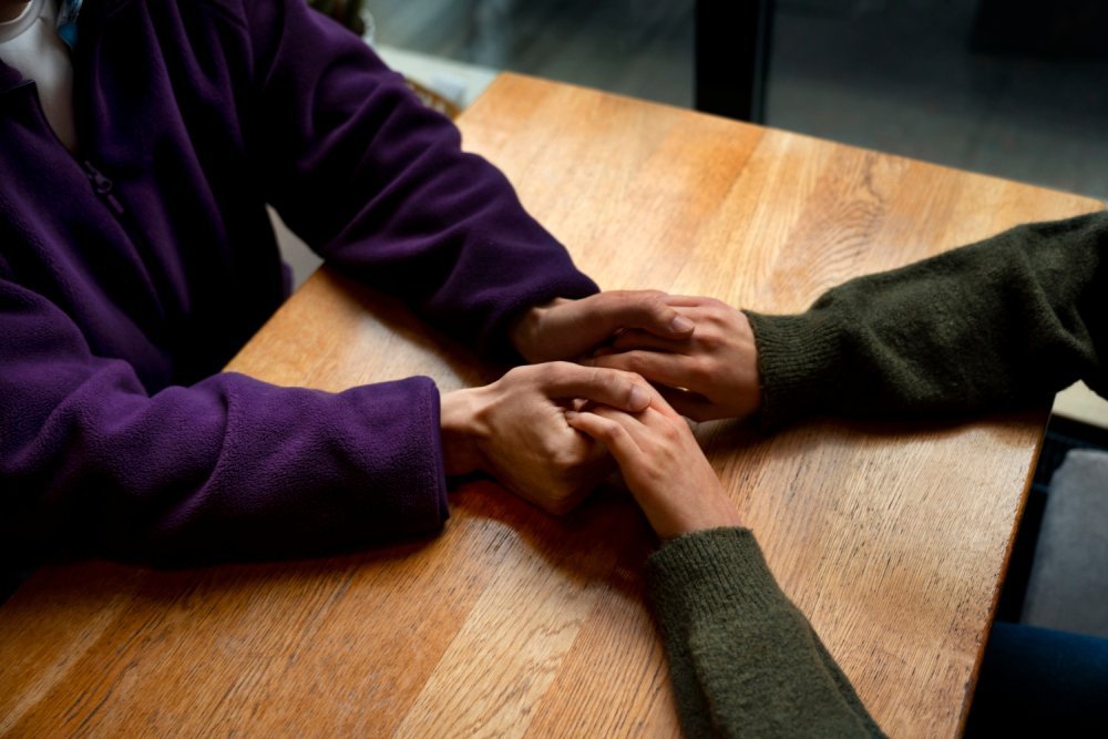 Hands holding each other for support