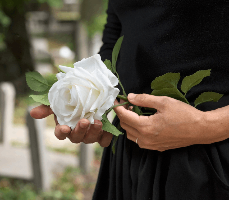 women in black dress with white rose